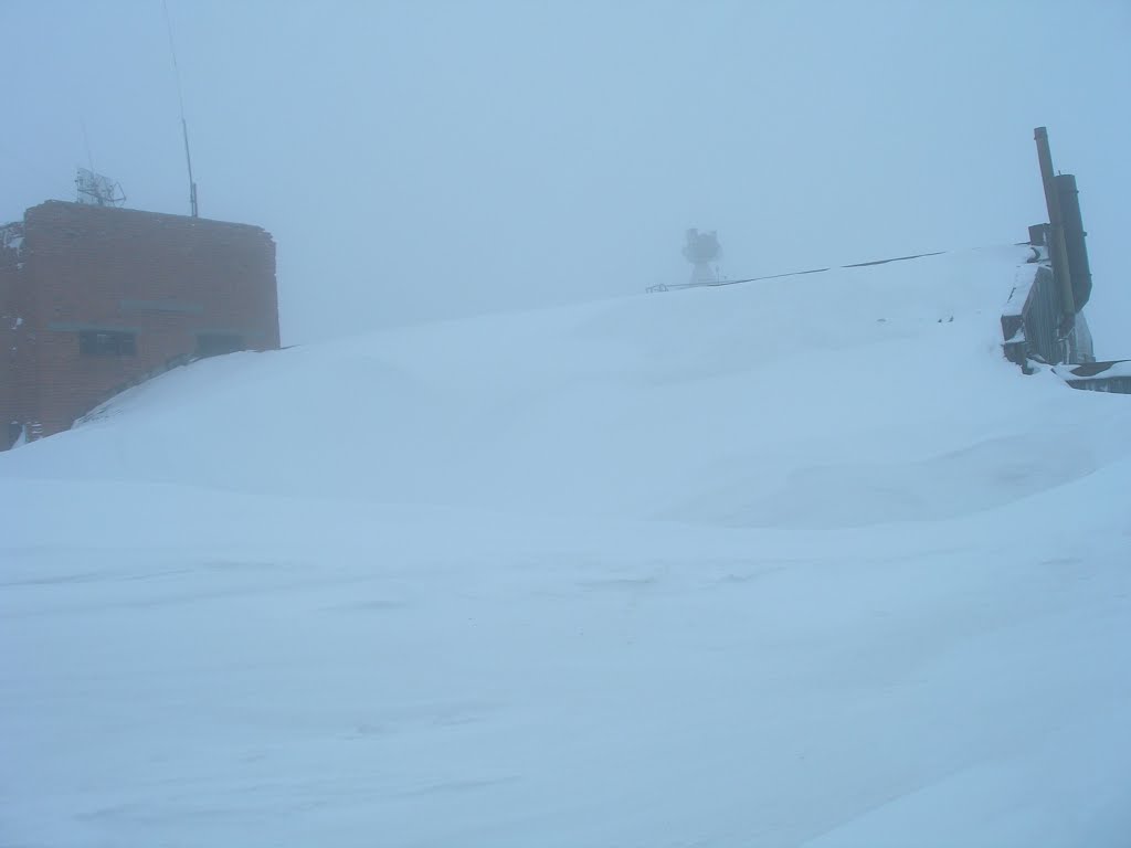 Right side of Vega MS technical facility in blizzard, snow drifts against buildings
